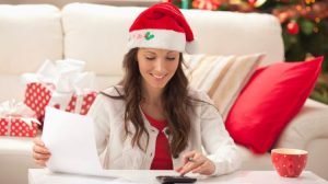 woman calculating her budget and spending after the holidays