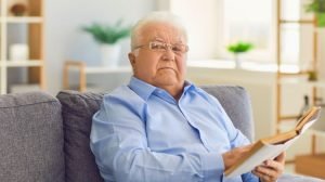 male senior reading a book