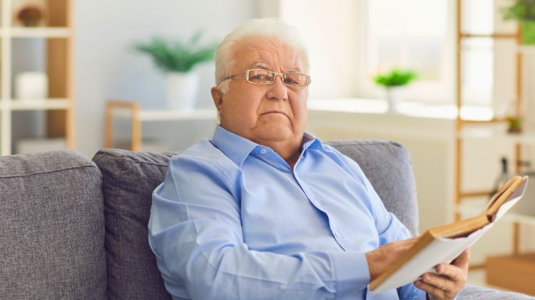 male senior reading a book