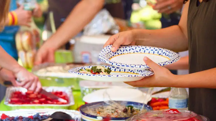 people gathering at a summer event eating food