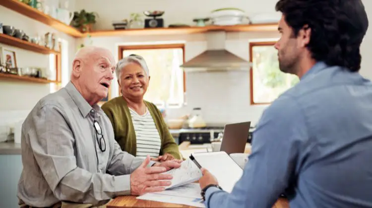 frugal homeowners discussing their budgets with a professional in their home