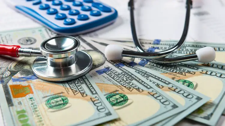 stack of money under a stethoscope