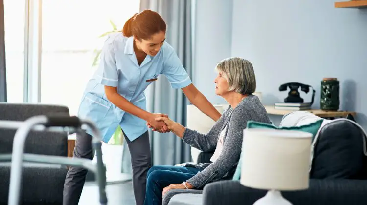 elderly woman being helped by nurse