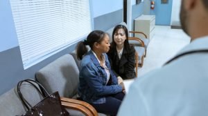 woman crying in hospital with support and doctor in photo
