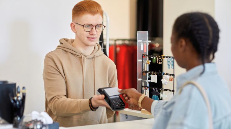 woman checking out with credit card at store