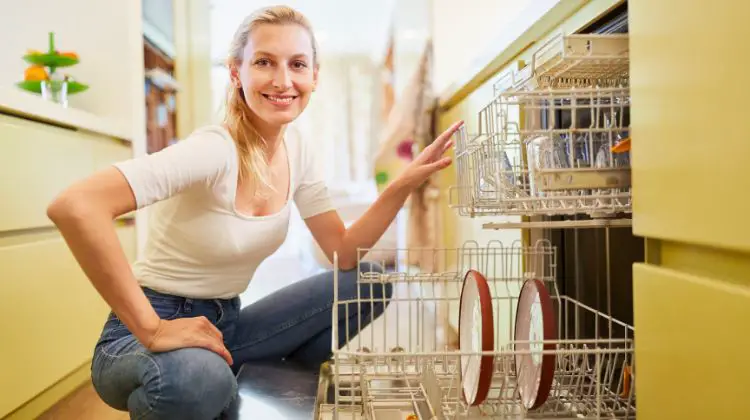 woman sitting by dishwasher