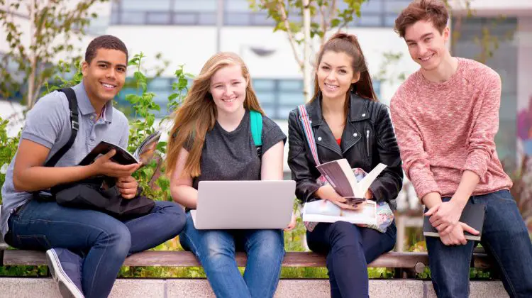 college students sitting together on bench