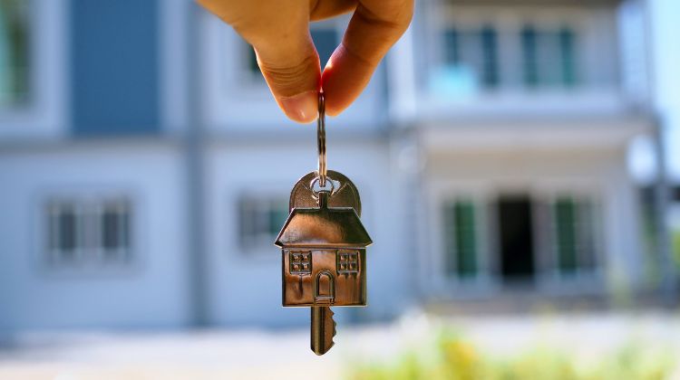 keys to a new home with a home in the background