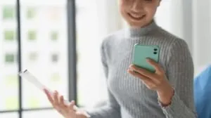 woman looking at phone performing a background check