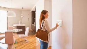 woman arming home security system