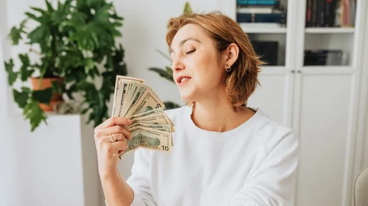 woman fanning herself with money