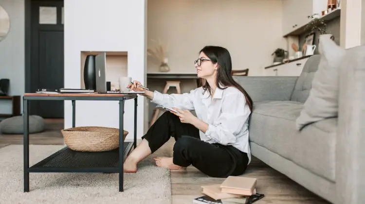 woman sitting on floor with her laptop