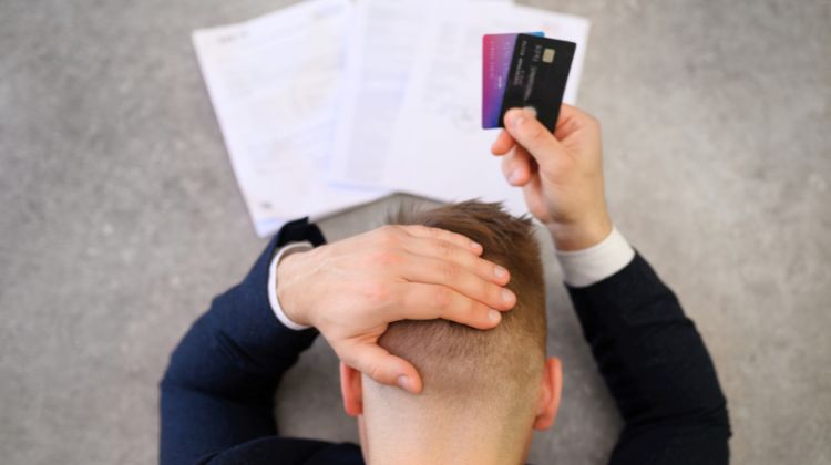 man sad about credit card debt