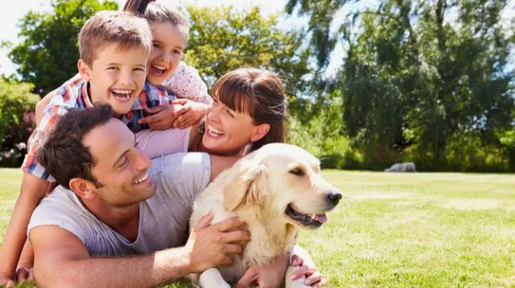 family of 4 outside with their dog